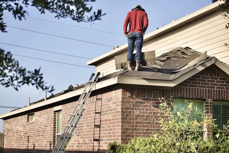Professional roofer working on a residential roof in Champions East